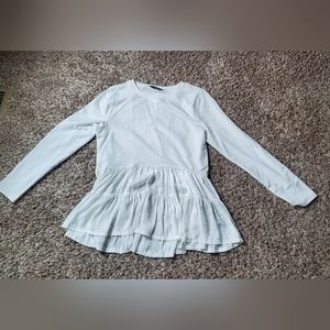 Long sleeved, ruffle bottom